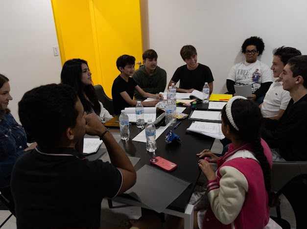 The full &ldquo;Brothers&rdquo; cast seated around the table read