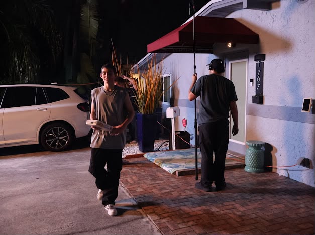Nicolás Devoto walking with his sides on the night shoot as crew resets
